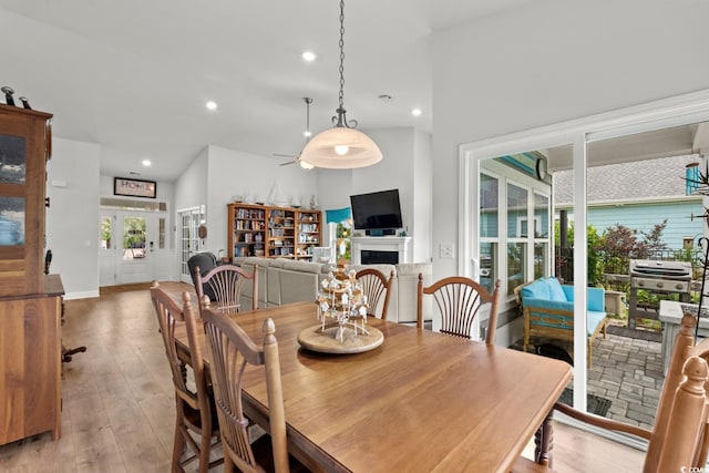 1833 Lake Egret Dr, North Myrtle Beach, SC 29582 - dining area with light wood-style flooring, recessed lighting, a fireplace, and a ceiling fan