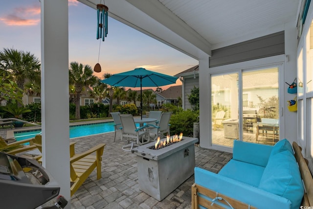 1833 Lake Egret Dr, North Myrtle Beach, SC 29582 - patio terrace at dusk with an outdoor fire pit, a patio, and an outdoor pool