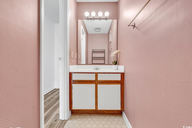 3700 Golf Colony Ln Unit 25G, Little River, SC 29566 - bathroom featuring vanity and wallpapered walls