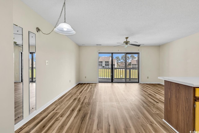 3700 Golf Colony Ln Unit 25G, Little River, SC 29566 - empty room featuring light wood-style flooring, a ceiling fan, and a textured ceiling