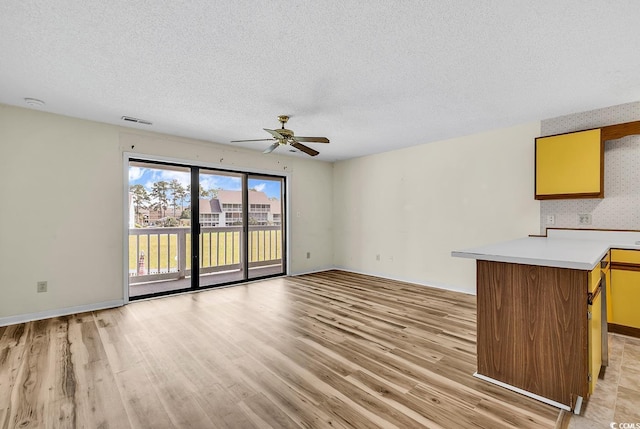 3700 Golf Colony Ln Unit 25G, Little River, SC 29566 - unfurnished living room featuring light wood-style floors, ceiling fan, and a textured ceiling