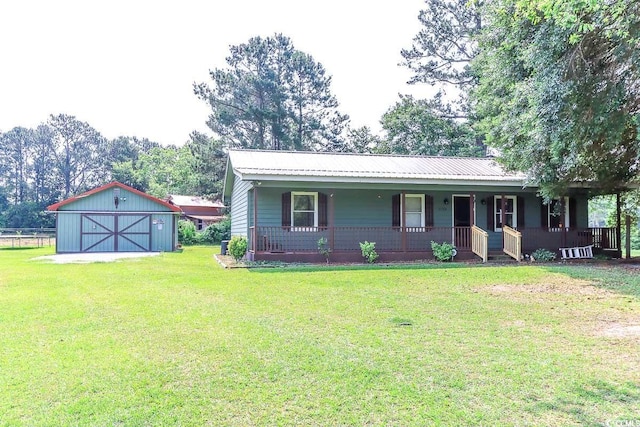 3150 Dusty Rd, Loris, SC 29569 - view of front of home with covered porch, a front yard, an outbuilding, a detached garage, and a metal roof