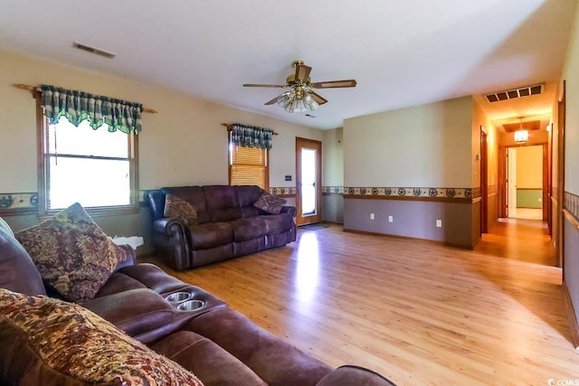 3150 Dusty Rd, Loris, SC 29569 - living area featuring wood finished floors, healthy amount of natural light, and ceiling fan
