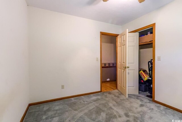 3150 Dusty Rd, Loris, SC 29569 - unfurnished bedroom with carpet flooring, a closet, and a ceiling fan