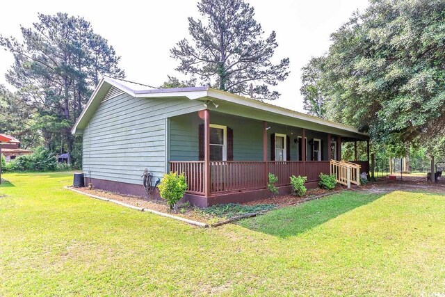 3150 Dusty Rd, Loris, SC 29569 - view of side of home with covered porch and a yard