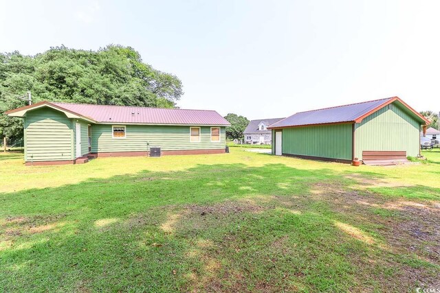 3150 Dusty Rd, Loris, SC 29569 - rear view of house with a lawn and a metal roof
