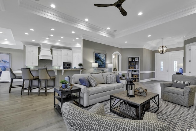 1108 Surf Pointe Dr, North Myrtle Beach, SC 29582 - living room with a tray ceiling, crown molding, light wood-type flooring, ceiling fan, and recessed lighting