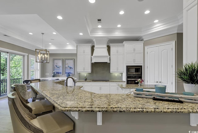 1108 Surf Pointe Dr, North Myrtle Beach, SC 29582 - kitchen featuring a raised ceiling, premium range hood, black electric stovetop, oven, and crown molding