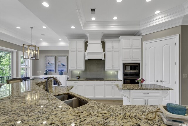 1108 Surf Pointe Dr, North Myrtle Beach, SC 29582 - kitchen with black appliances, a sink, crown molding, custom exhaust hood, and a center island