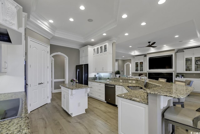 1108 Surf Pointe Dr, North Myrtle Beach, SC 29582 - kitchen with a raised ceiling, black appliances, a sink, arched walkways, and crown molding