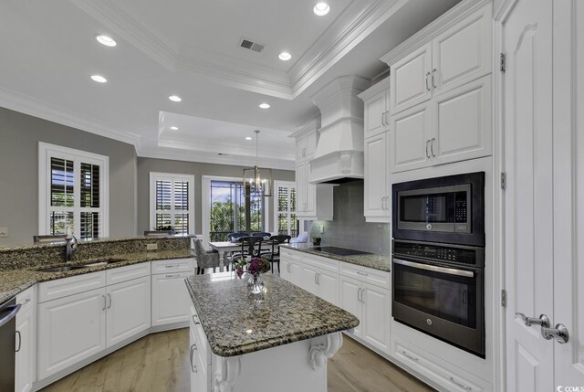 1108 Surf Pointe Dr, North Myrtle Beach, SC 29582 - kitchen with black appliances, a sink, a raised ceiling, healthy amount of natural light, and crown molding