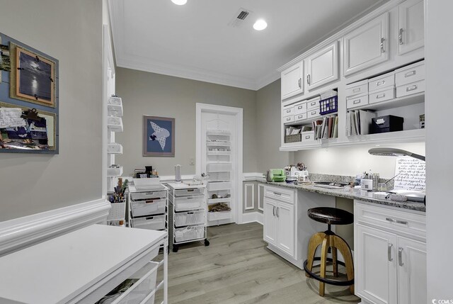 1108 Surf Pointe Dr, North Myrtle Beach, SC 29582 - kitchen featuring ornamental molding, white cabinets, light wood-style floors, recessed lighting, and light stone counters