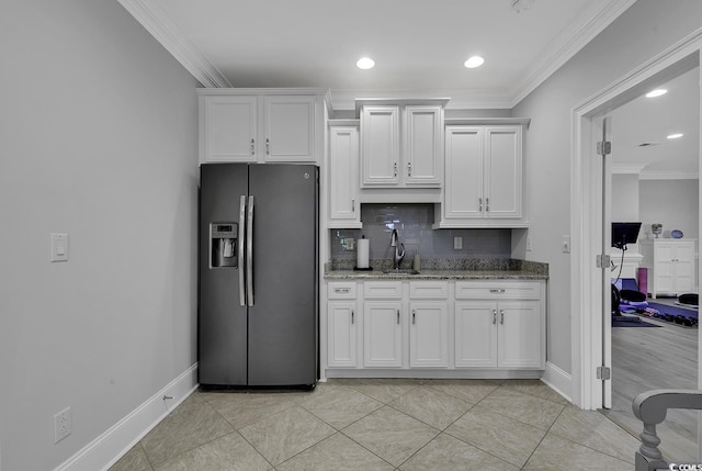 1108 Surf Pointe Dr, North Myrtle Beach, SC 29582 - kitchen featuring stainless steel fridge with ice dispenser, crown molding, backsplash, white cabinetry, and light stone countertops