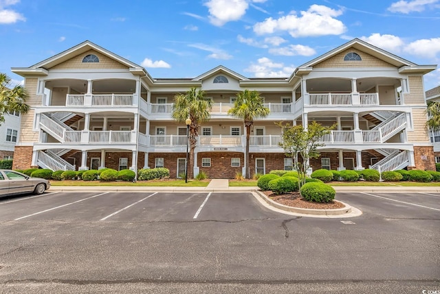 6015 Catalina Dr Unit 733, North Myrtle Beach, SC 29582 - view of property featuring stairs and uncovered parking