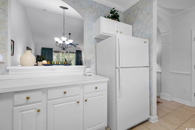 6015 Catalina Dr Unit 733, North Myrtle Beach, SC 29582 - kitchen with freestanding refrigerator, arched walkways, white cabinetry, a chandelier, and crown molding