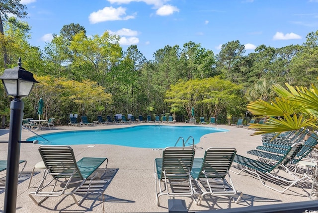 6015 Catalina Dr Unit 733, North Myrtle Beach, SC 29582 - community pool with a patio and view of scattered trees