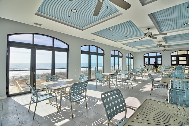 6015 Catalina Dr Unit 733, North Myrtle Beach, SC 29582 - dining room with ceiling fan, a water view, healthy amount of natural light, and coffered ceiling