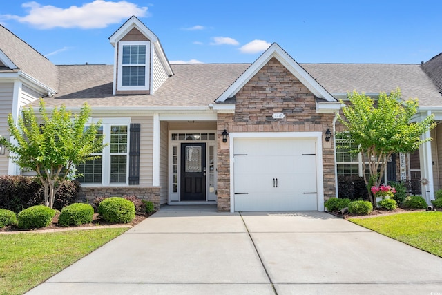121 Parmelee Dr Unit D, Murrells Inlet, SC 29576 - view of front facade featuring stone siding, driveway, a garage, and a shingled roof