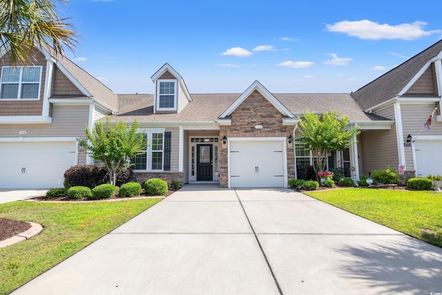 121 Parmelee Dr Unit D, Murrells Inlet, SC 29576 - view of front of property with stone siding, concrete driveway, a front yard, and roof with shingles