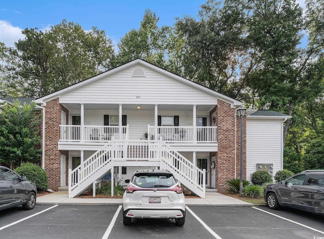 157 Egret Run Ln Unit 523, Pawleys Island, SC 29585 - view of building exterior featuring stairway and uncovered parking