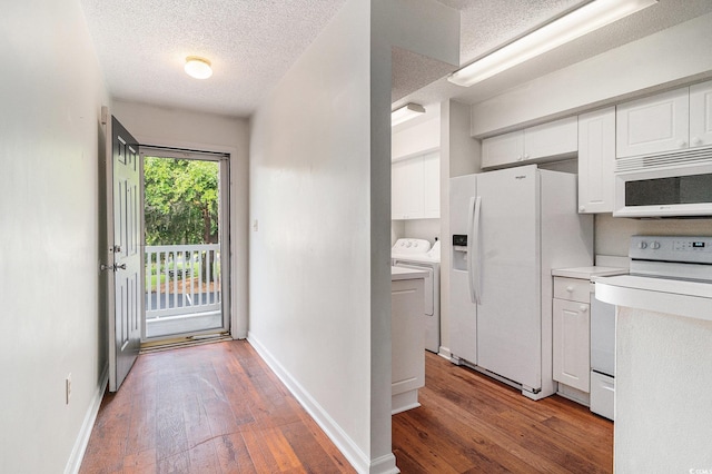 157 Egret Run Ln Unit 523, Pawleys Island, SC 29585 - kitchen with white appliances, white cabinets, a textured ceiling, separate washer and dryer, and wood-type flooring