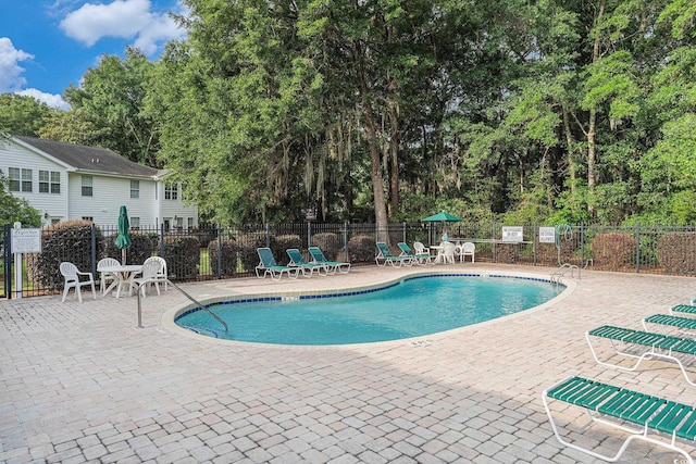 157 Egret Run Ln Unit 523, Pawleys Island, SC 29585 - community pool featuring a patio area and view of scattered trees