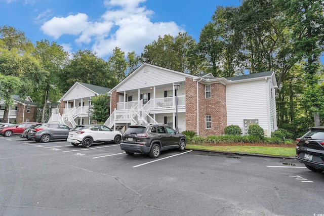 157 Egret Run Ln Unit 523, Pawleys Island, SC 29585 - view of building exterior featuring stairway and uncovered parking