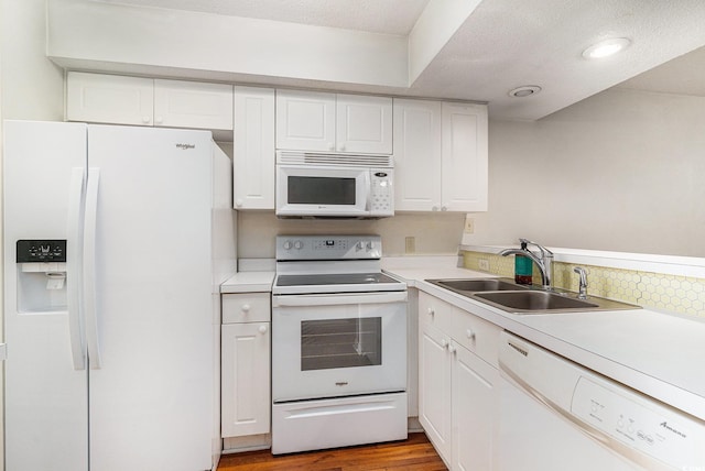 157 Egret Run Ln Unit 523, Pawleys Island, SC 29585 - kitchen with white appliances, white cabinetry, light countertops, light wood-style floors, and a textured ceiling