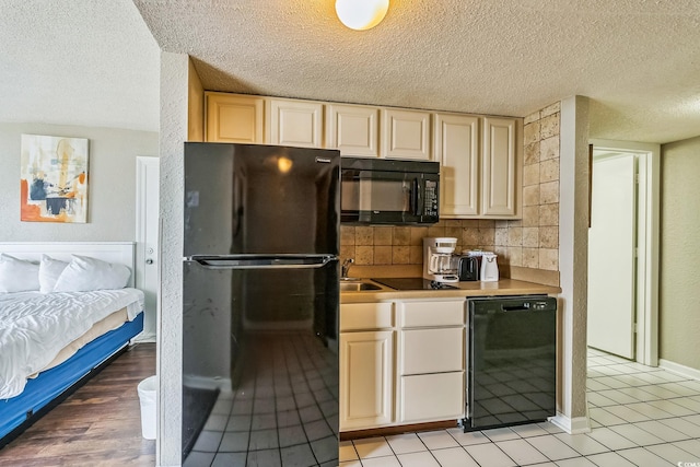 9550 Shore Dr Unit 1418, Myrtle Beach, SC 29572 - kitchen featuring black appliances, a textured ceiling, a sink, light countertops, and open floor plan
