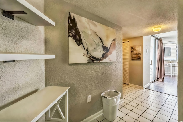 9550 Shore Dr Unit 1418, Myrtle Beach, SC 29572 - dining area featuring a textured wall, tile patterned flooring, a textured ceiling, and baseboards