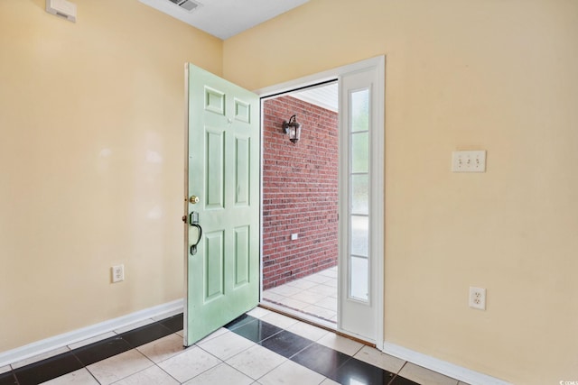 2384 Covington Dr, Myrtle Beach, SC 29579 - foyer entrance with baseboards, brick wall, and tile patterned flooring