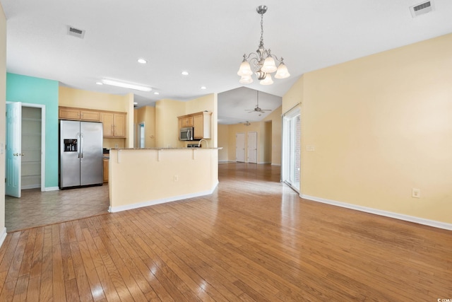 2384 Covington Dr, Myrtle Beach, SC 29579 - kitchen with stainless steel appliances, open floor plan, a chandelier, a peninsula, and baseboards