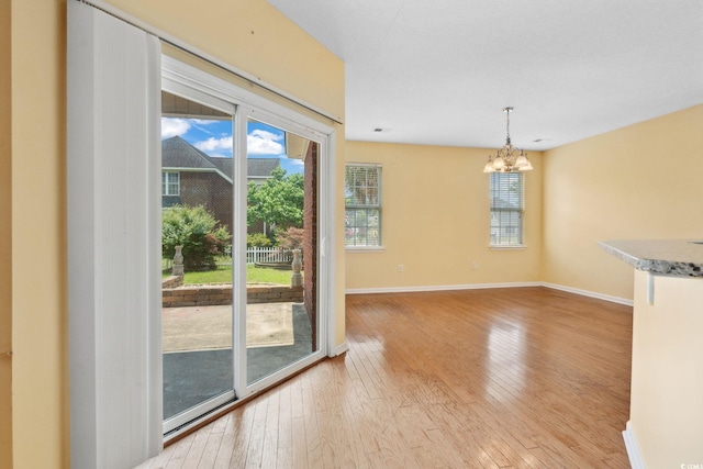 2384 Covington Dr, Myrtle Beach, SC 29579 - unfurnished dining area with a chandelier, light wood-style floors, and baseboards