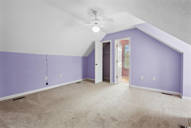 2384 Covington Dr, Myrtle Beach, SC 29579 - additional living space featuring carpet, ceiling fan, a textured ceiling, baseboards, and vaulted ceiling