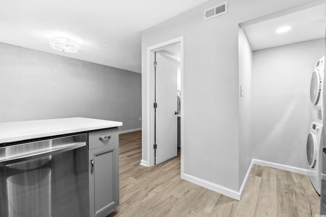 315 73rd Ave N Unit 2, Myrtle Beach, SC 29572 - washroom with stacked washer / drying machine and light wood-style flooring