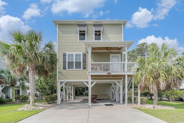 58 Fathom Ln, Murrells Inlet, SC 29576 - raised beach house with driveway, a carport, and a porch