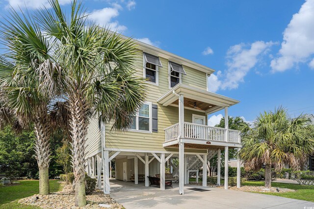 58 Fathom Ln, Murrells Inlet, SC 29576 - coastal home featuring a carport, concrete driveway, and stairway