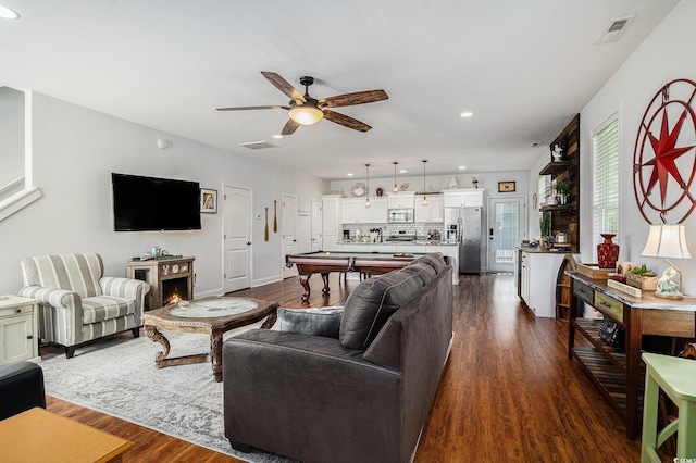 58 Fathom Ln, Murrells Inlet, SC 29576 - living room with dark wood-style floors, a ceiling fan, recessed lighting, baseboards, and a lit fireplace