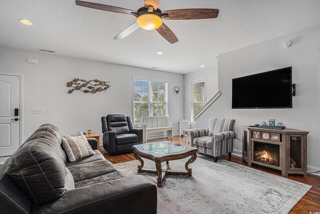 58 Fathom Ln, Murrells Inlet, SC 29576 - living area with dark wood finished floors, ceiling fan, recessed lighting, baseboards, and a warm lit fireplace