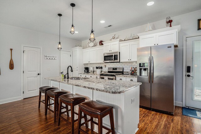 58 Fathom Ln, Murrells Inlet, SC 29576 - kitchen featuring stainless steel appliances, a sink, dark wood-type flooring, white cabinetry, and recessed lighting