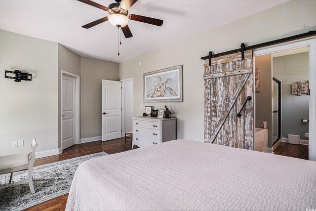 58 Fathom Ln, Murrells Inlet, SC 29576 - bedroom with a barn door, dark wood-type flooring, baseboards, a ceiling fan, and connected bathroom