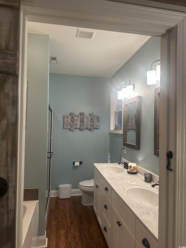 58 Fathom Ln, Murrells Inlet, SC 29576 - bathroom featuring a bath, double vanity, wood finished floors, a shower with door, and baseboards