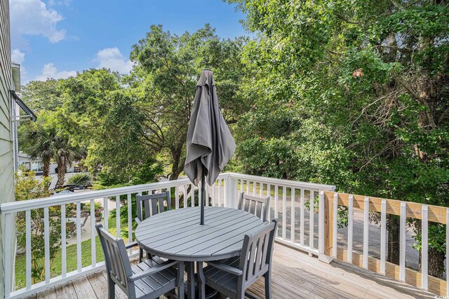 58 Fathom Ln, Murrells Inlet, SC 29576 - deck featuring outdoor dining space and view of scattered trees