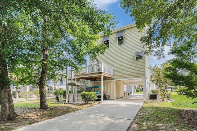 58 Fathom Ln, Murrells Inlet, SC 29576 - view of front of house featuring a carport, driveway, and central air condition unit