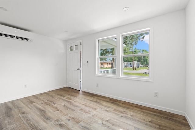 1004 Georgetown St, Marion, SC 29571 - unfurnished room featuring a wall mounted AC, wood finished floors, and baseboards