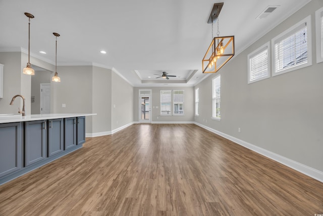 2080 Silver Island Way, Murrells Inlet, SC 29576 - unfurnished living room featuring a raised ceiling, a ceiling fan, light wood finished floors, recessed lighting, and baseboards