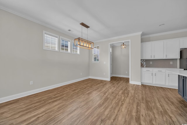 2080 Silver Island Way, Murrells Inlet, SC 29576 - unfurnished living room with light wood-style floors, ornamental molding, baseboards, and a chandelier