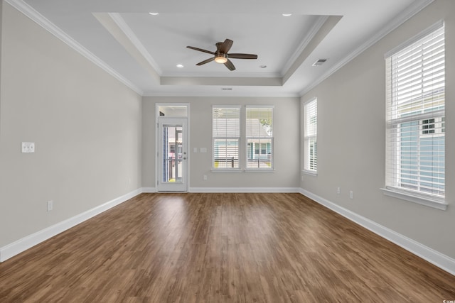 2080 Silver Island Way, Murrells Inlet, SC 29576 - unfurnished living room featuring dark wood-style floors, ceiling fan, a tray ceiling, baseboards, and ornamental molding