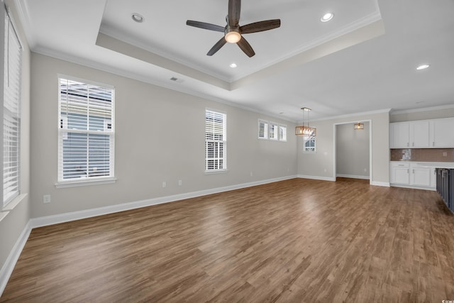 2080 Silver Island Way, Murrells Inlet, SC 29576 - unfurnished living room with a raised ceiling, ornamental molding, wood finished floors, a ceiling fan, and baseboards