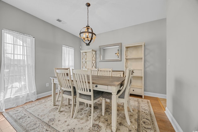 4232 Pointer Ct, Myrtle Beach, SC 29579 - dining area featuring a chandelier, baseboards, and wood finished floors